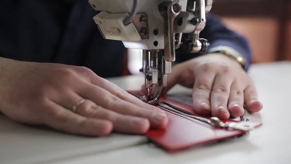 Master Hands, Who Uses a Sewing Machine To Create Stitches on a Leather Wallet, the alt