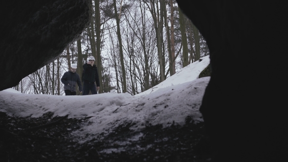 Two Speleologists Exploring the Cave in Darkness alt