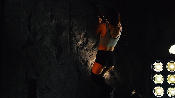 Sporty Fitness Model Girl in Shorts Performing Pull-ups with Chains alt