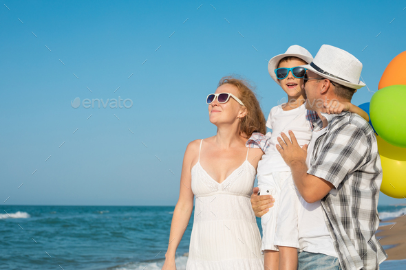 Father mother and son playing on the beach at the day time. - Stock Photo - Images