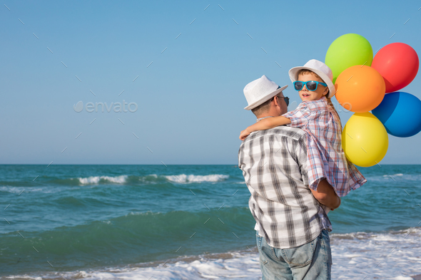 Father and son playing on the beach at the day time. - Stock Photo - Images