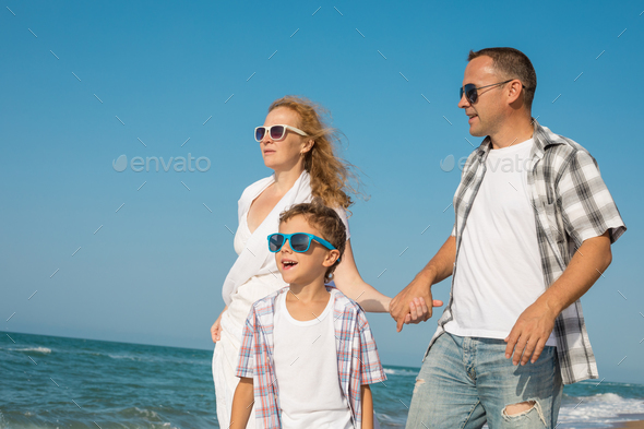 Father mother and son playing on the beach at the day time. - Stock Photo - Images