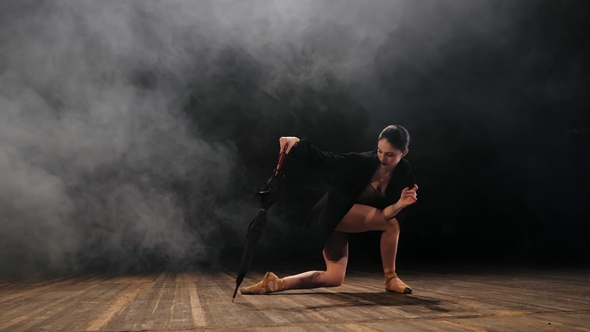 Ballerina in Black Long Jacket on Sexy Bodysuit Dancing on Stage with Magic Light and Smoke alt