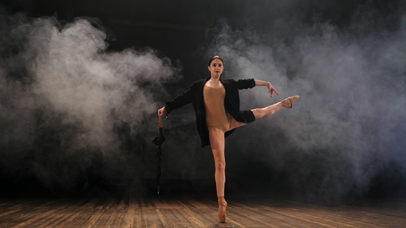 Ballerina in Black Long Jacket on Sexy Bodysuit Dancing on Stage with Magic Light and Smoke alt