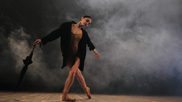 Ballerina in Black Long Jacket on Sexy Bodysuit Dancing on Stage with Magic Light and Smoke alt