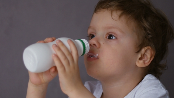 Boy Drinking Milk From the Bottle