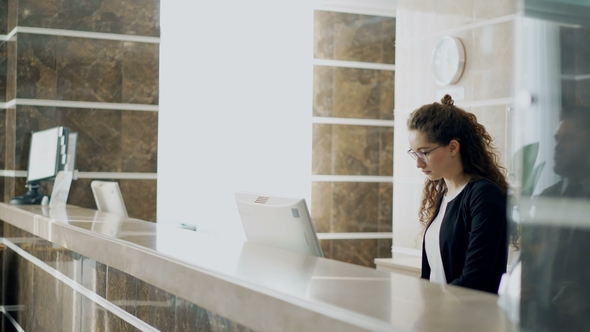 Businessman and Businesswoman Guests Come To Receptionist Standing at Desk and Paying Bill with alt