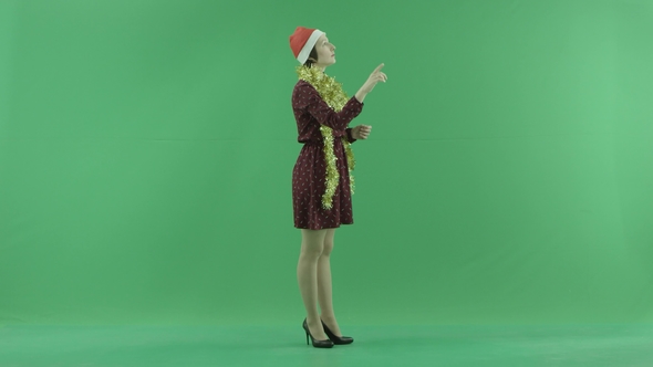 A Young Christmas Woman Is Searching for Something on a Big Touch Screen on the Right Hand Side on