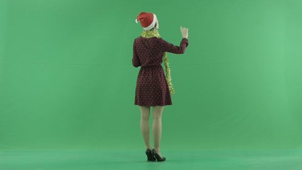 A Young Christmas Woman Is Searching for Something on a Big Touch Screen on the Back To the Viewer