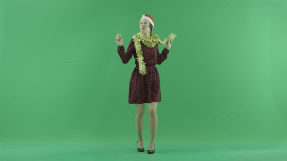 A Young Woman Is Dancing To the Viewer Side in the Center of the Green Screen