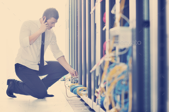 it engeneer talking by phone at network room - Stock Photo - Images