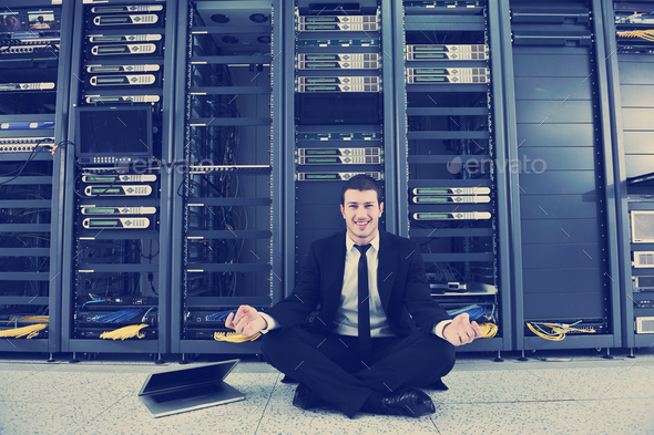 business man practice yoga at network server room - Stock Photo - Images