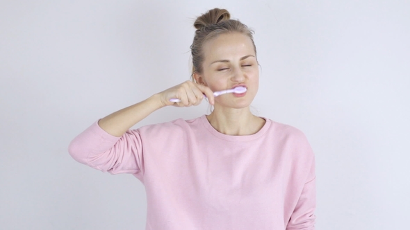 Young Woman Cleaning Teeth with Toothbrush