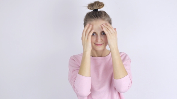 Young Woman Applying Cream on Her Face