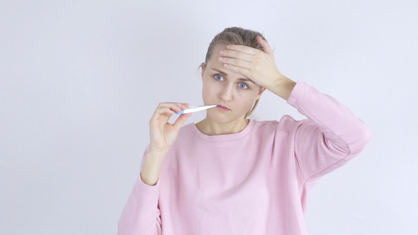 Sick Young Woman with Thermometer in Her Mouth