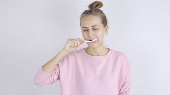 Cute Young Woman Cleaning Her Teeth with Toothbrush