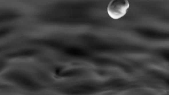 Super Slow Motion Shot of Water Drops Falling Into Water on Black Background at 1000 Fps. alt