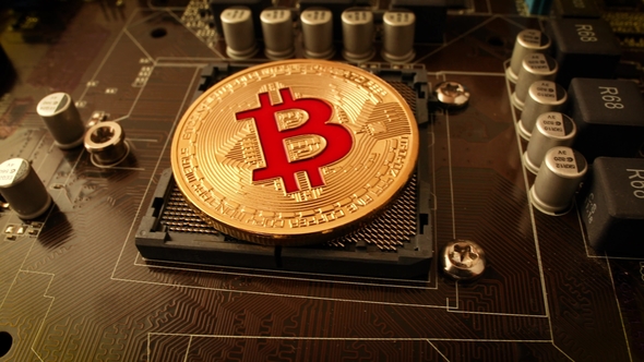 Gold Bit Coin BTC Coins on the Motherboard. Bitcoin Is a Worldwide Cryptocurrency alt