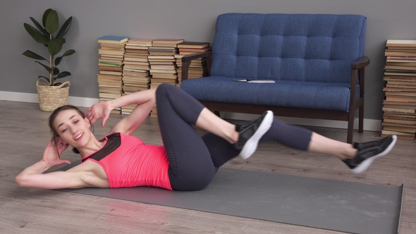Young Fitness Woman Doing Bicycle Crunch Exercise on Mat at Home alt
