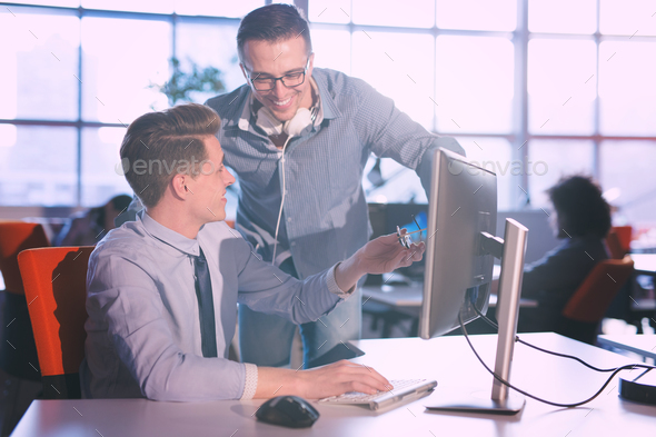 Two Business People Working With computer in office Stock Photo by dotshock