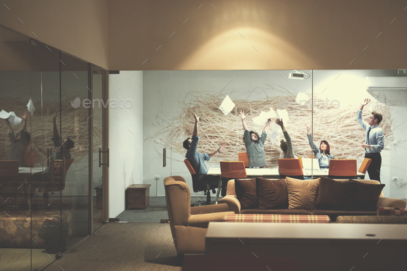 Group of young business people throwing documents - Stock Photo - Images