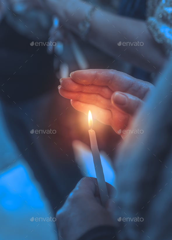 Believer in a church with candle - Stock Photo - Images