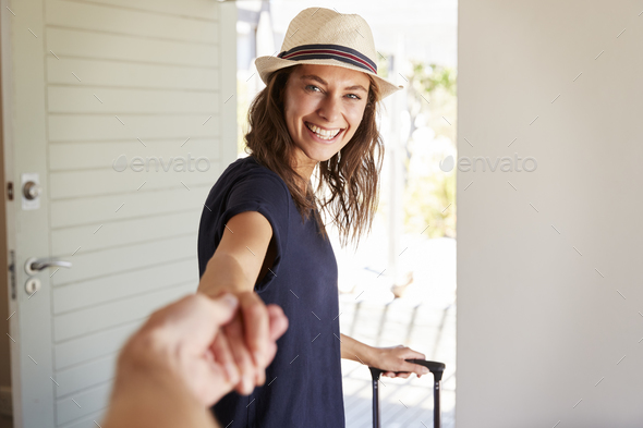 Point Of View Shot Of Couple Leaving Home For Vacation Stock Photo by monkeybusiness