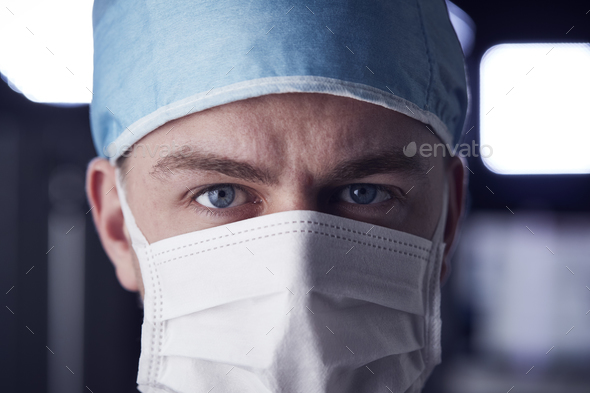 Male healthcare worker in scrubs, head shot Stock Photo by monkeybusiness