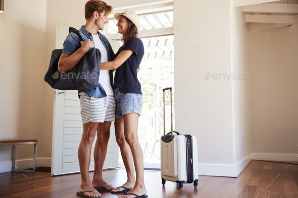 Couple Arriving At Summer Vacation Rental Stock Photo by monkeybusiness