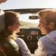 Young adult couple driving looking at each other - $5.00 Young adult couple driving looking at each other