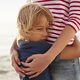 Close Up Of Mother Hugging Son On Summer Beach Vacation - $5.00 Close Up Of Mother Hugging Son On Summer Beach Vacation