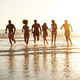Group Of Friends Run Through Waves Together On Beach Vacation - $5.00 Group Of Friends Run Through Waves Together On Beach Vacation
