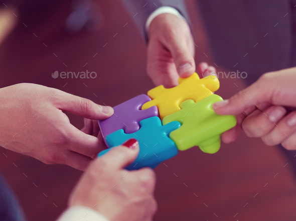 business people group assembling jigsaw puzzle - Stock Photo - Images