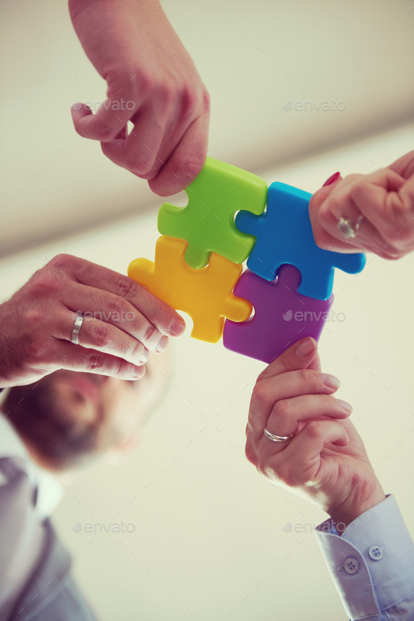 business people group assembling jigsaw puzzle Stock Photo by dotshock