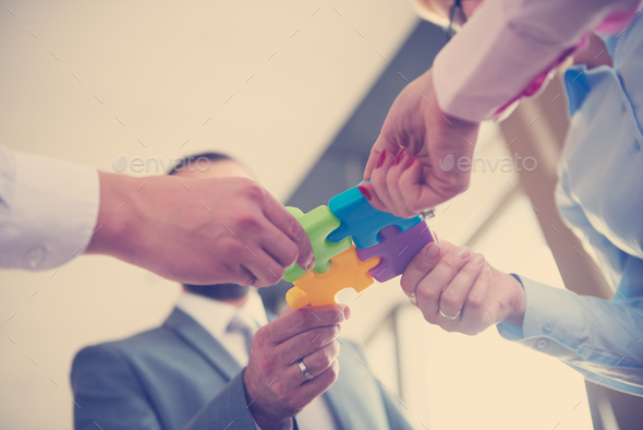 business people group assembling jigsaw puzzle Stock Photo by dotshock