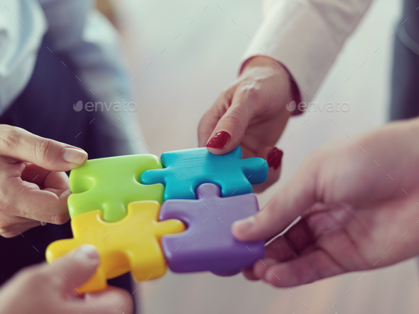 business people group assembling jigsaw puzzle - Stock Photo - Images