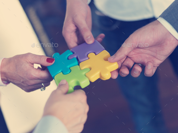 business people group assembling jigsaw puzzle - Stock Photo - Images