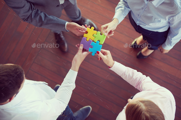 business people group assembling jigsaw puzzle Stock Photo by dotshock