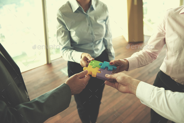 business people group assembling jigsaw puzzle - Stock Photo - Images