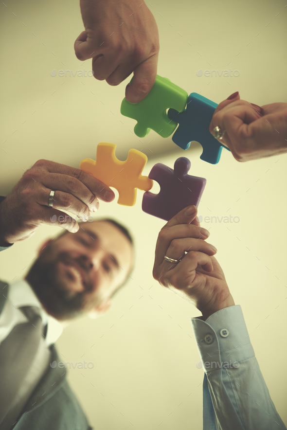 business people group assembling jigsaw puzzle Stock Photo by dotshock
