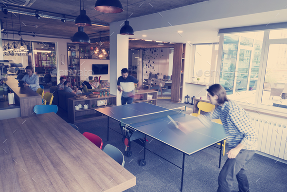 playing ping pong tennis at creative office space - Stock Photo - Images