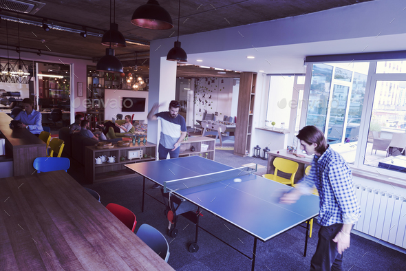 playing ping pong tennis at creative office space - Stock Photo - Images