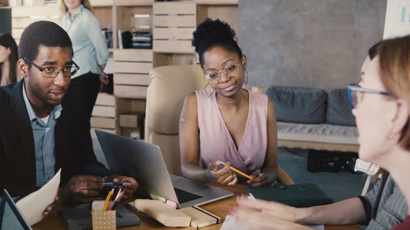 Mixed Ethnicity Team Meeting in Trendy Office. Happy Smiling Creative Millennials Brainstorm alt