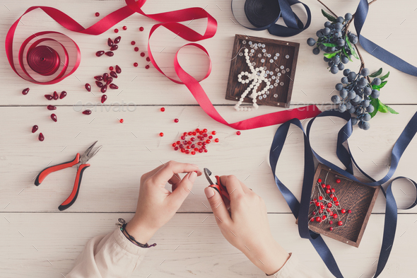 Woman making jewelry, home workshop, hobby - Stock Photo - Images