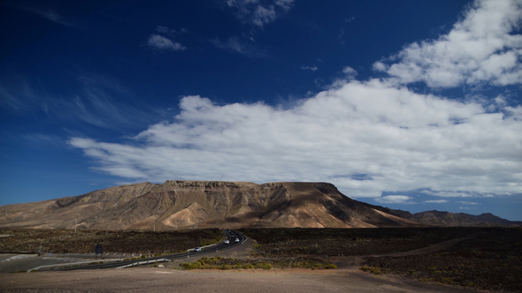 Busy Road in the Mountains with Moving Clouds alt