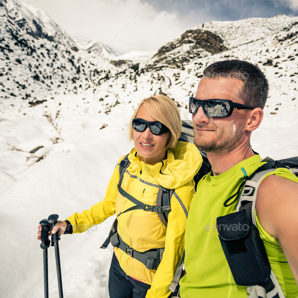Couple hikers, partnership and teamwork in winter mountains - Stock Photo - Images