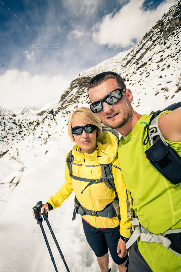 Couple hikers, partnership and teamwork in winter mountains - Stock Photo - Images