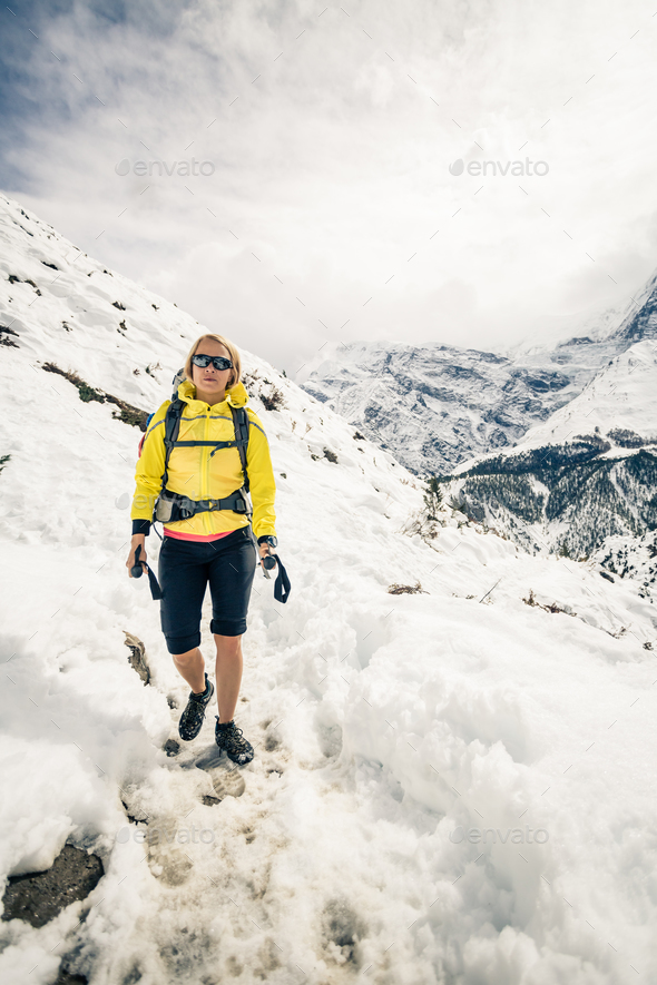 Woman hiker walking in Himalaya Mountains, Nepal - Stock Photo - Images