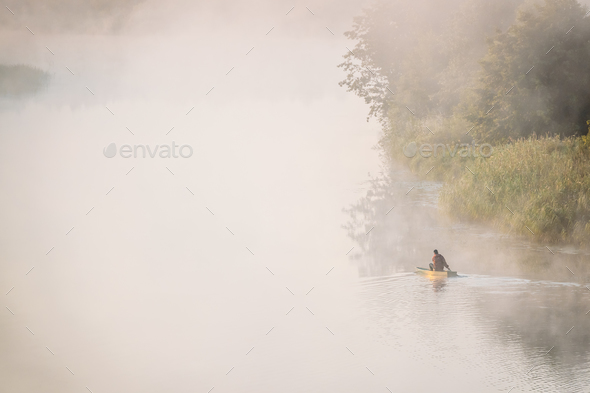 Calm Lake, River And Man Fishing From Old Wooden Rowing Fishing - Stock Photo - Images