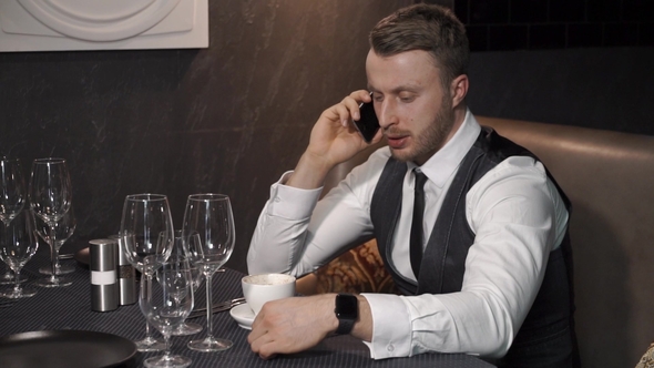 Businessman Is Calling Somebody in Cafe